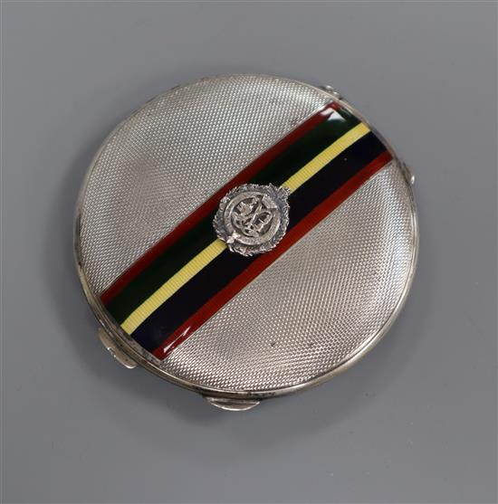 A 1930s silver and enamel compact with Sutherland and Argyle applique, 75mm.